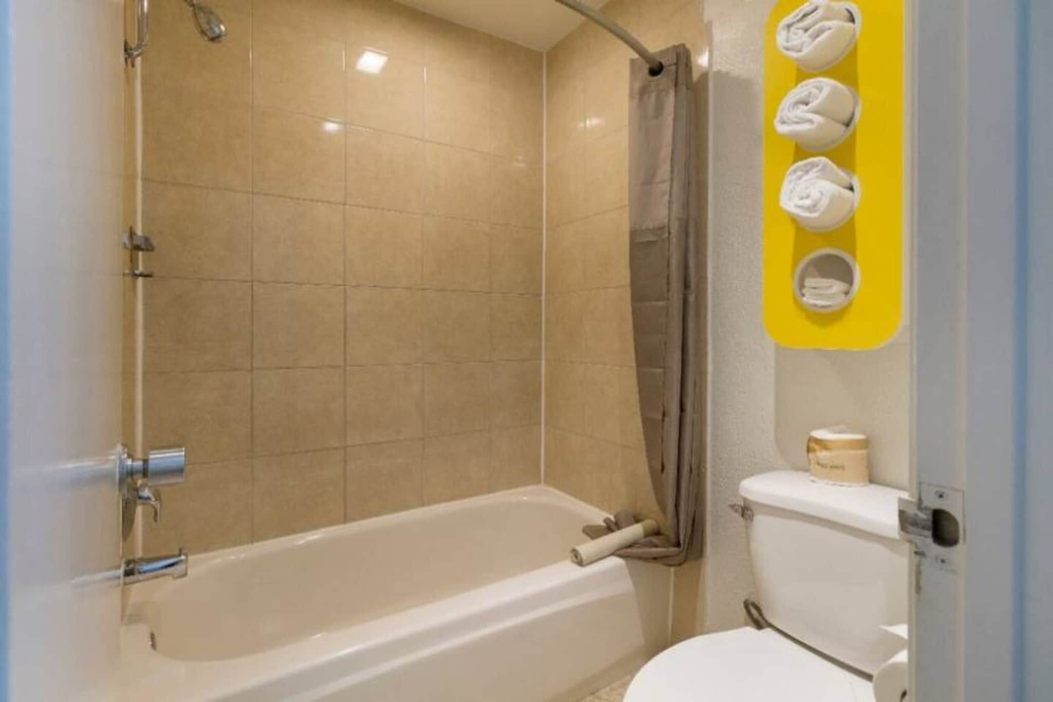 Ein Badezimmer mit Badewanne, Toilette und Duschvorhang.