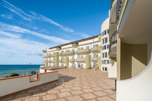 A multi-story building with balconies overlooking a body of water. - Carlton Hotel Riviera - Cefalu (Cefalù)