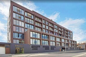 A multi-story building with a modern architectural design, featuring a series of balconies and large windows. - Serene 1-bedroom Apartment in Central Cape Town (Cape Town)