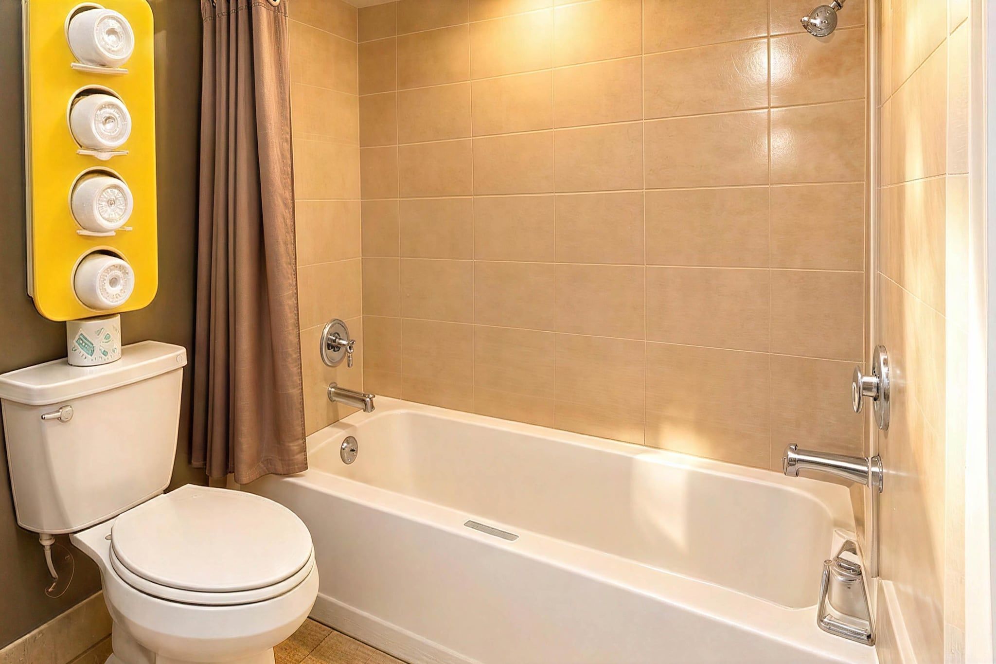 A bathroom with a toilet, a bathtub, and a shower.