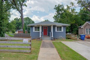 A single-story house with a red front door, a small porch, and a front yard. - < 1 Mi to MARTA! Extended Getaway 3 Mi to Dtwn (Atlanta)