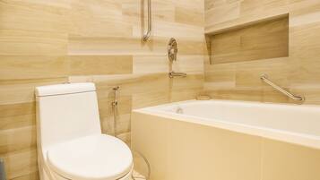 A bathroom with a toilet, a bathtub, and a shower.