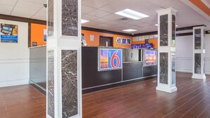 A hotel lobby with a reception desk, marble pillars, and a tiled floor. - Spacious King Bed|Free Wifi,Parking (Jonesboro)