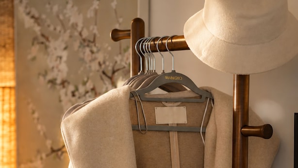 A clothing rack with a beige coat and a hat. - Zen Retreat: Cinema, Pet-Friendly Yard (Springwood)