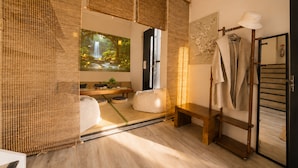 A room with a tatami mat floor, a wooden bench, a hanging robe, and a wall-mounted mirror. - Zen Retreat: Cinema, Pet-Friendly Yard (Springwood)