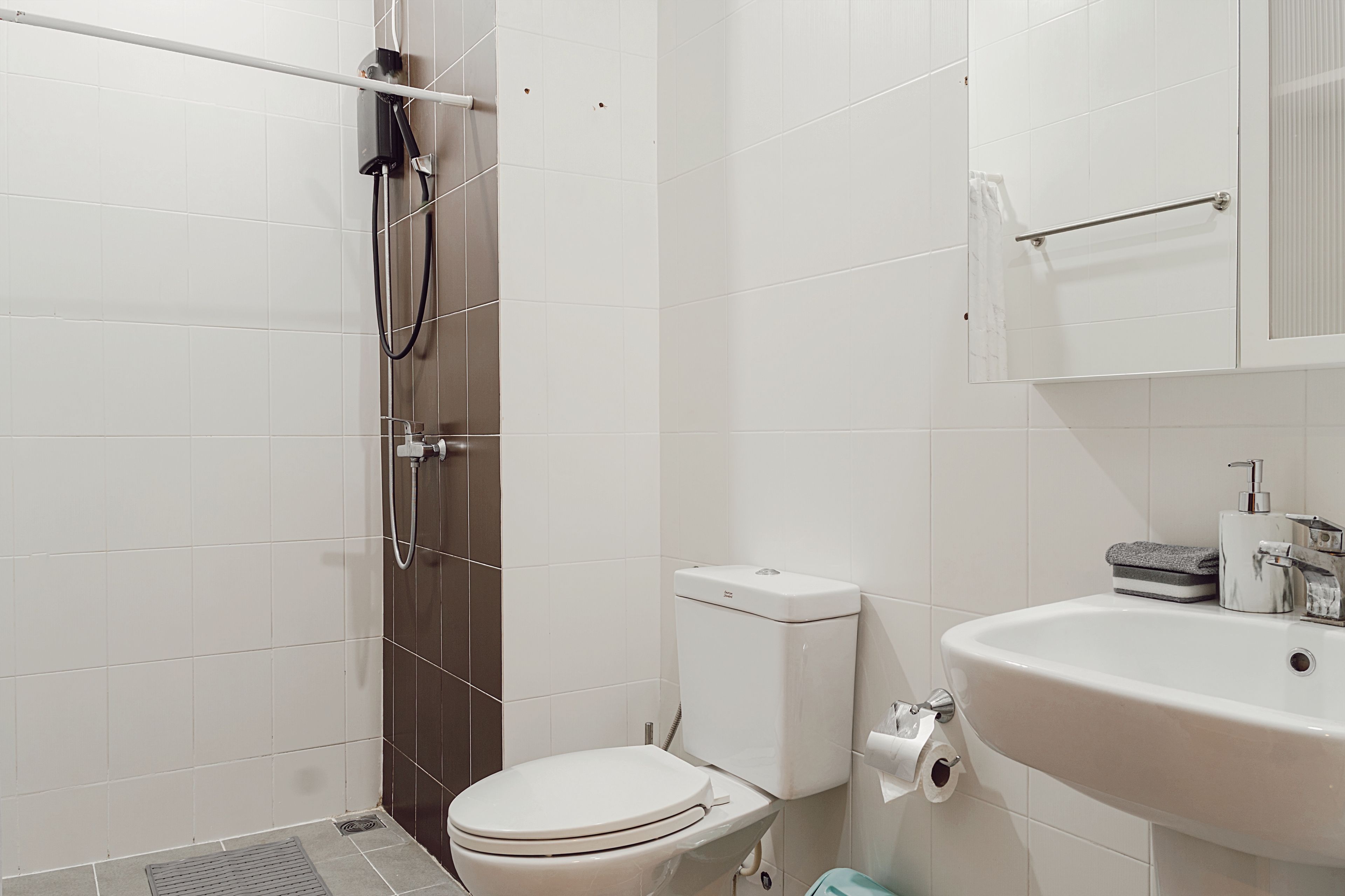 A bathroom with a toilet, a sink, and a shower.