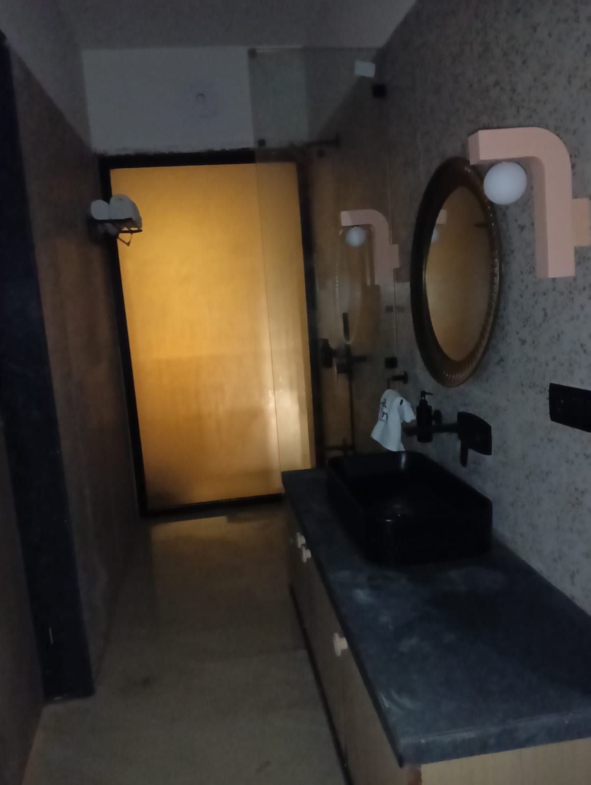 A bathroom with a sink, mirror, and towel rack.