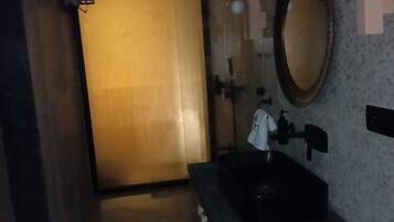 A bathroom with a sink, mirror, and towel rack.