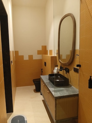 A small bathroom with a sink, mirror, and toilet.