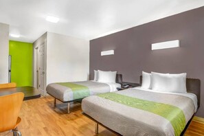 A hotel room with two beds, a desk, and a chair. - 2 Full bed | Smoking (CHAMBLEE)