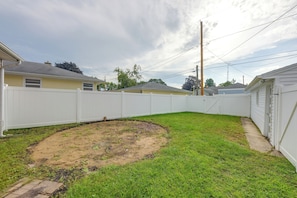 A fenced backyard with a grassy area and a concrete slab. - Kenosha Mid-Term Rental w/ Fenced Yard (Kenosha)
