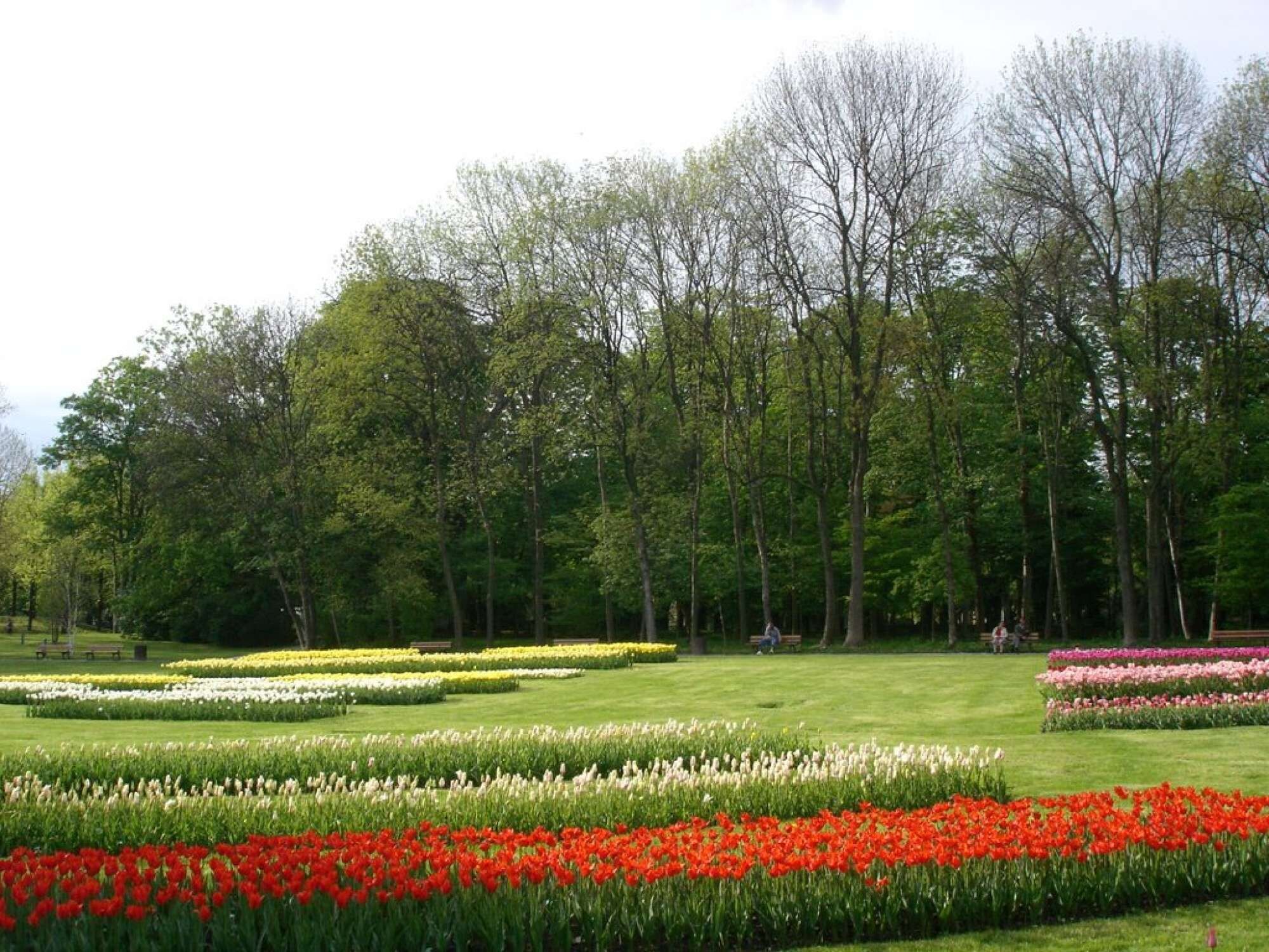 A park with flower beds and trees.