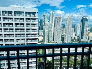 A high-rise building with multiple balconies and a cityscape in the background. - Royal Fame Residence (Mandaluyong City)