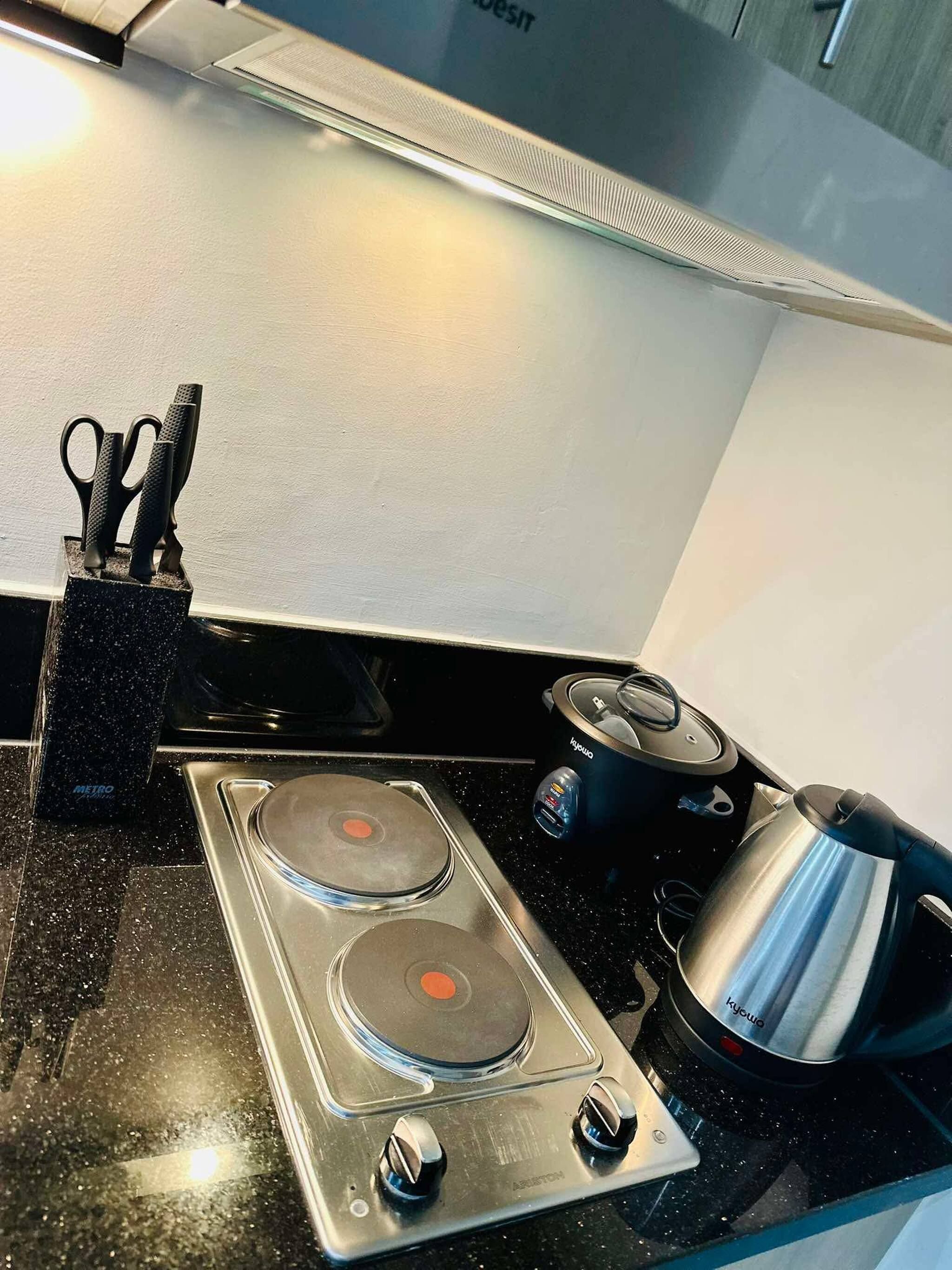 Coffee/tea maker, fridge, stovetop, cookware/dishes/utensils