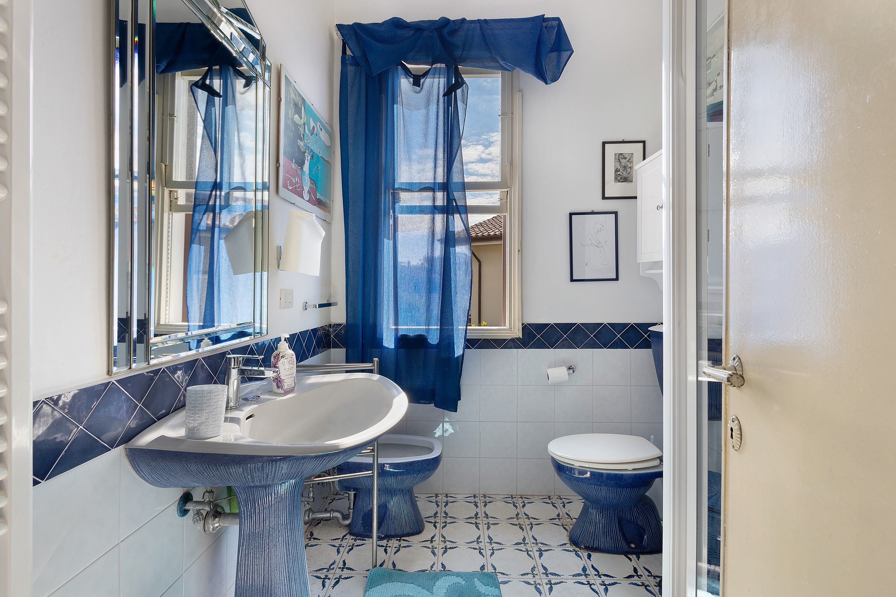 A bathroom with a sink, toilet, and shower area.