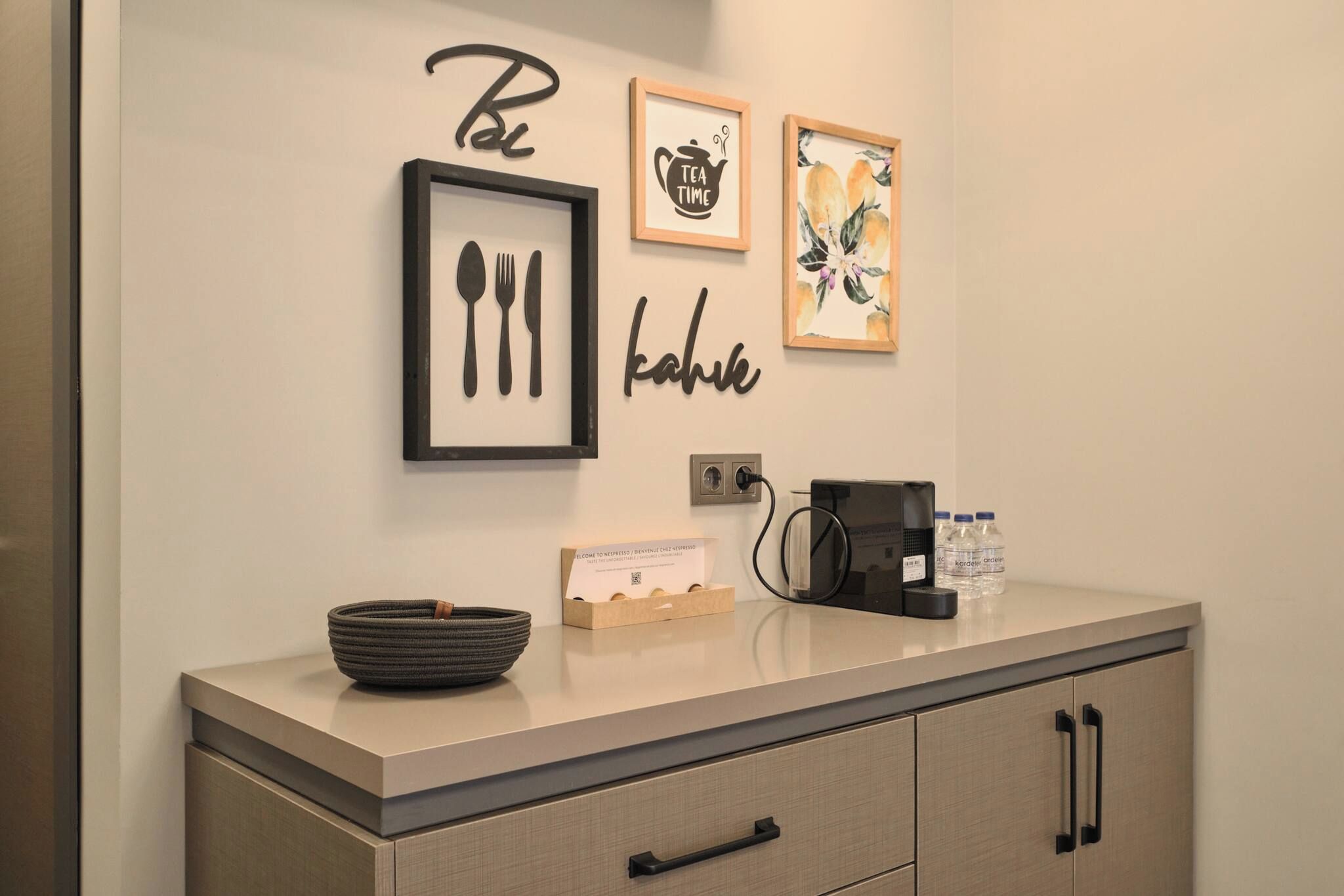 A kitchenette with a coffee machine, a bowl, and a card dispenser.