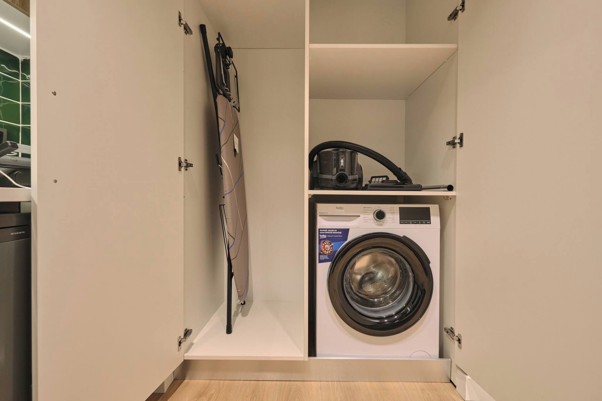 A compact laundry room with a front-loading washing machine and a drying machine.