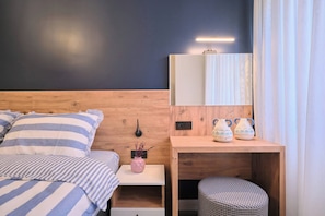 A bedroom with a bed, bedside table, and a mirror. - Vega, Modern 2BR, Best Loc (Kadıköy)