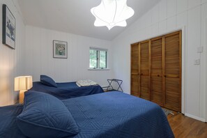 A bedroom with two beds, a window, a wardrobe, and a hanging light fixture. - Long-Range Views in Gated Wolf Laurel/Ski/Ashville (Mars Hill)