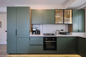A modern kitchen with built-in appliances, a gas stove, and a dishwasher. - Sirius, Modern 2BR, Best Loc (Kadıköy)