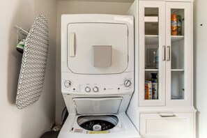 A compact laundry room with a washing machine, dryer, and storage cabinet. - < 1 Mi to Fort Jackson: Condo w/ Private Patio (Columbia)