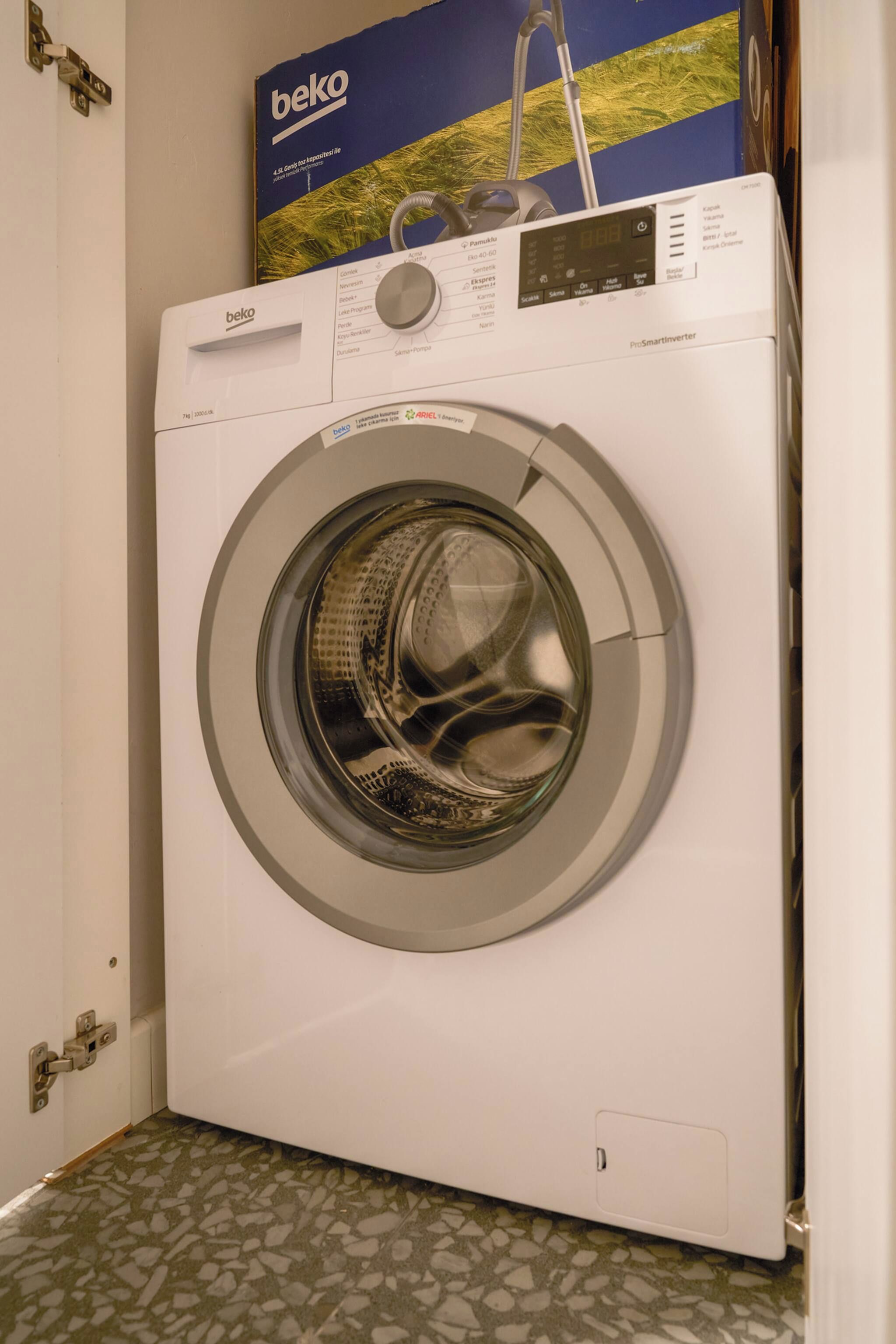 A front-loading washing machine with a control panel and a digital display.