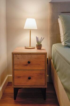 A wooden bedside table with a lamp and a small potted plant. - Renovated, Stylish, 3BR Kadıköy (Kadıköy)