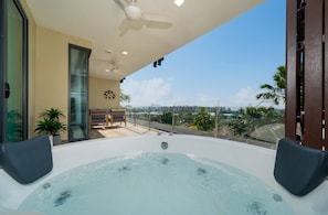 A hot tub on a balcony with a view of the city. - Apartment with Sea View and Hot Tub on Balcony (Rawai)