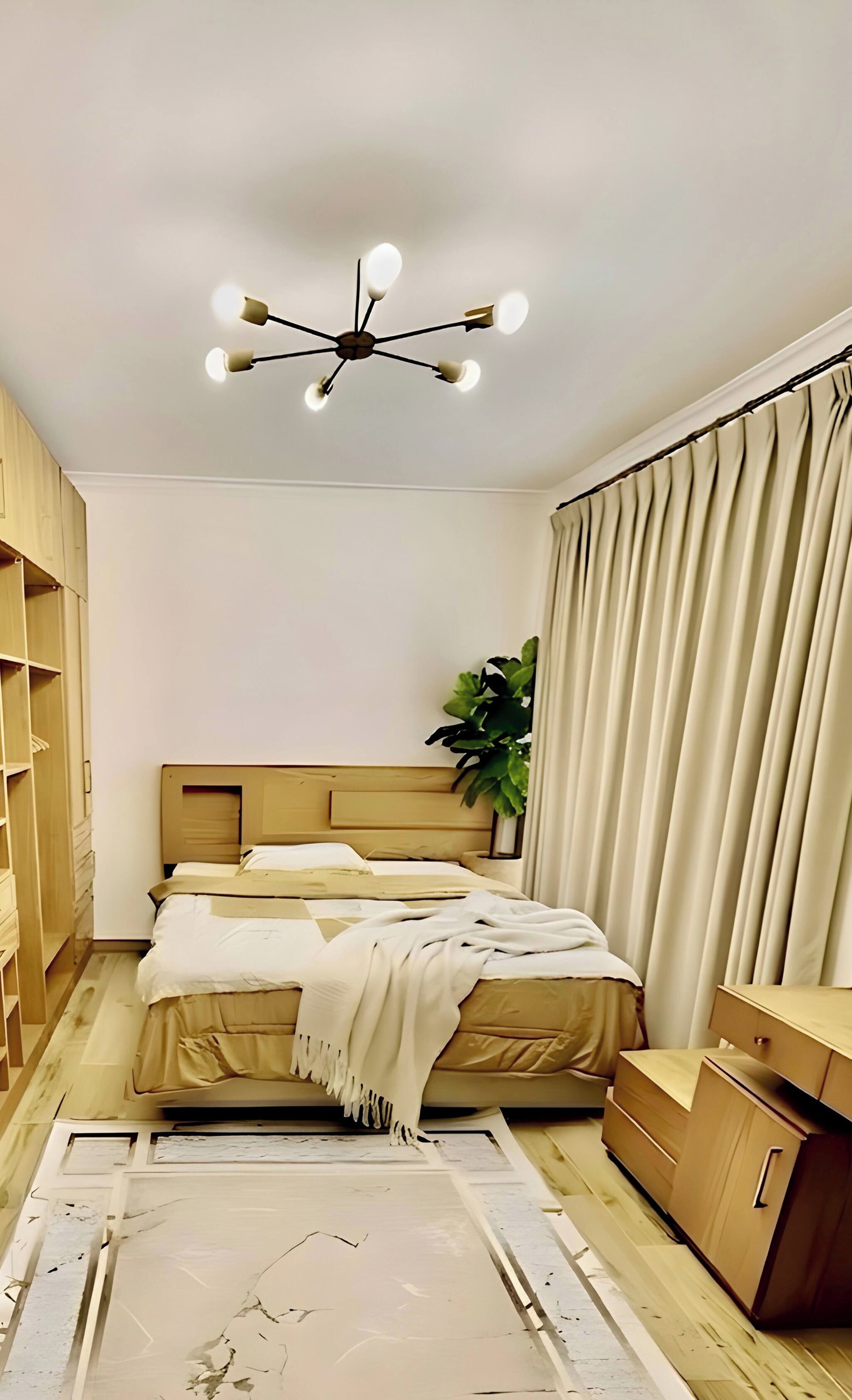 A bedroom with a bed, a ceiling light fixture, a plant, and a wardrobe.
