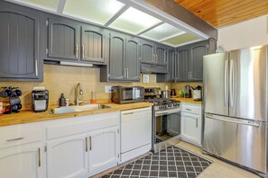A modern kitchen with grey cabinets, stainless steel appliances, and a wooden countertop. - 1 Mi to Snow Play! 4-Season Big Bear Escape (Big Bear)