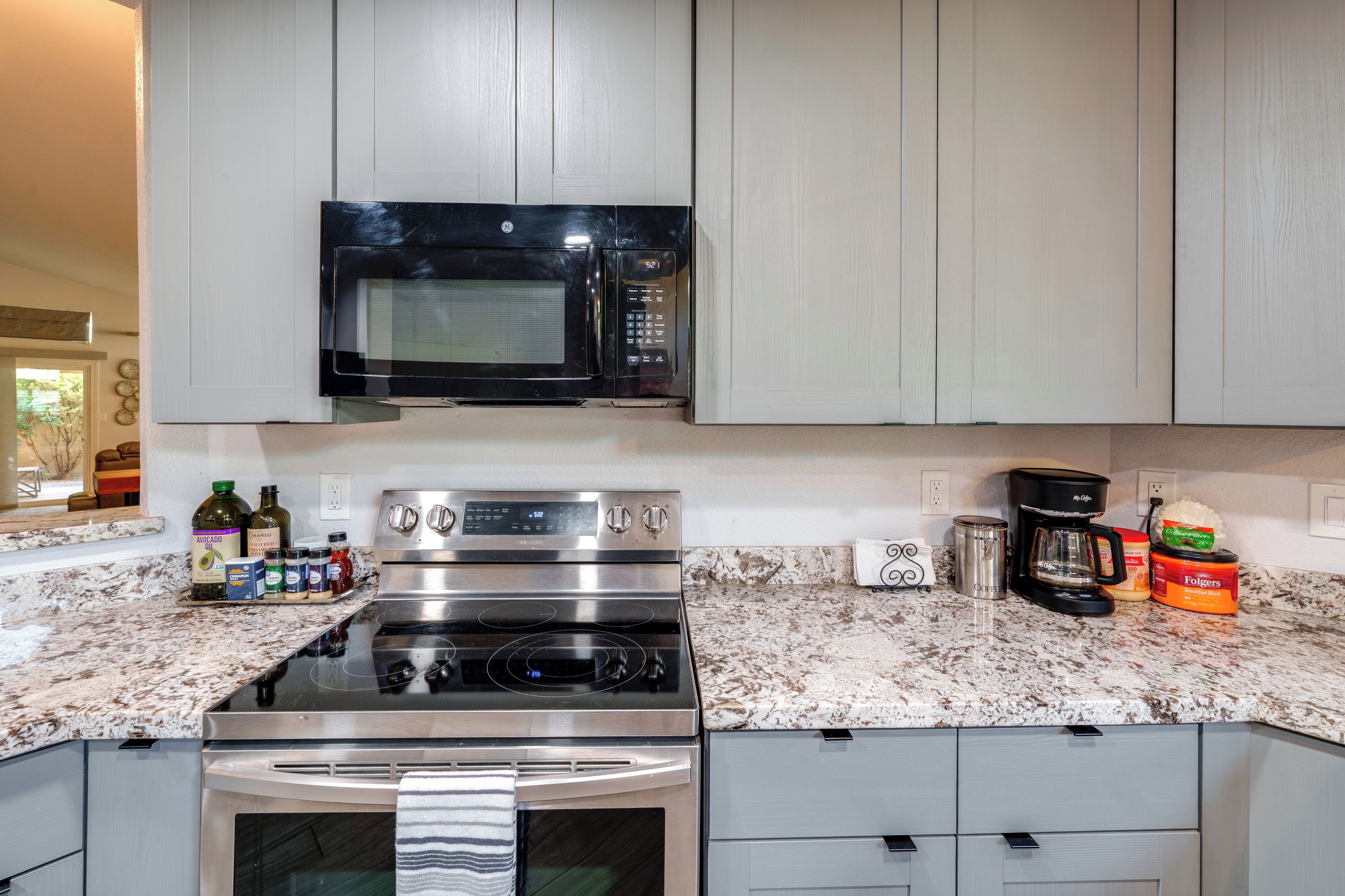 A modern kitchen with a built-in microwave, stove, and oven.