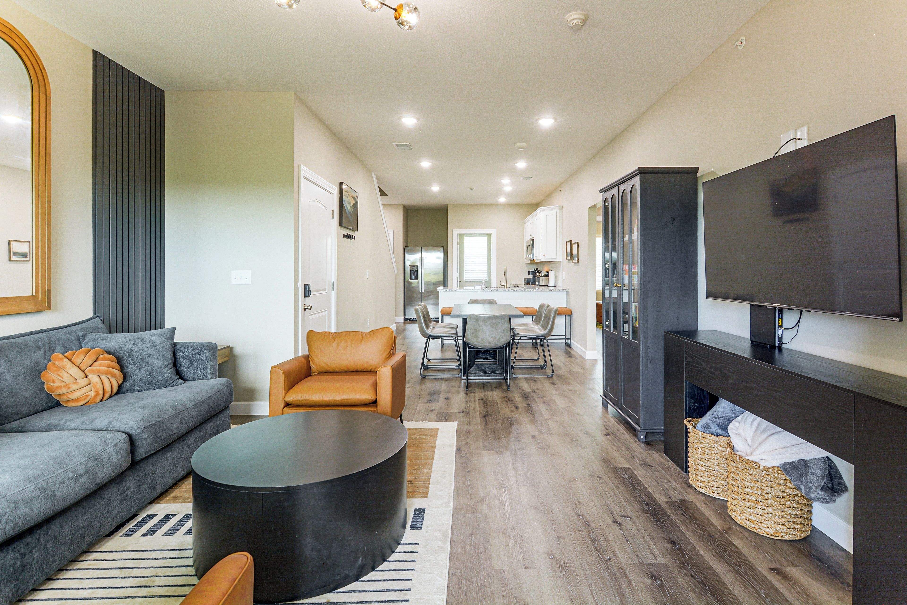 A modern living room with a sofa, a coffee table, and a television.