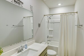 A bathroom with a shower, toilet, and sink. - Screened Porch: Newly Built Townhome in Madison (Madison)