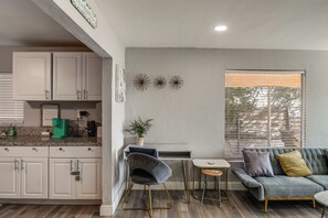 A modern kitchen with white cabinets, a coffee machine, and a potted plant. - Bakersfield Home w/ Workspace, Near Hospitals (Bakersfield)