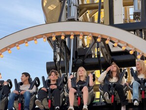 A group of people seated in a ride with a circular frame and overhead lights. - Apartment in Södermalm (Stockholm)