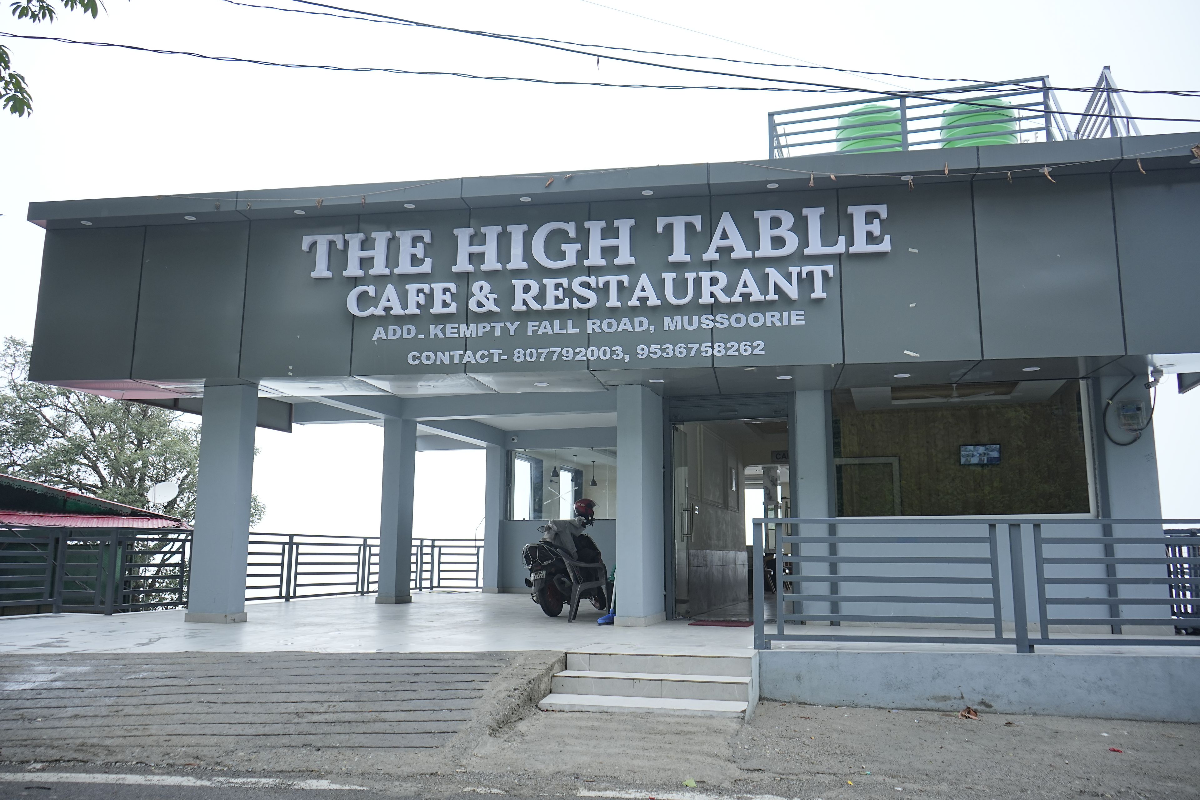 A building with a sign reading 'The High Table Cafe & Restaurant.'