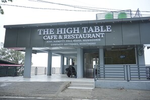 A building with a sign reading 'The High Table Cafe & Restaurant.'