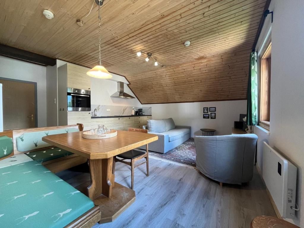 A modern interior with a dining area, kitchen, and seating space.