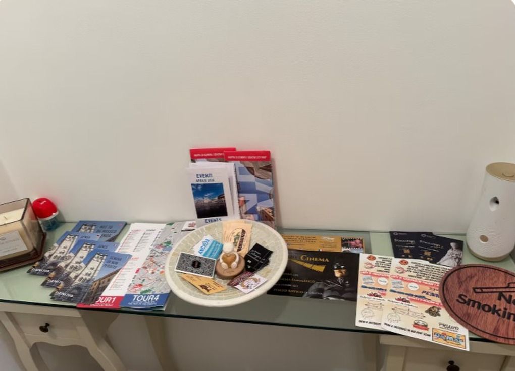 A glass-top table with brochures, a small globe, and a decorative item.