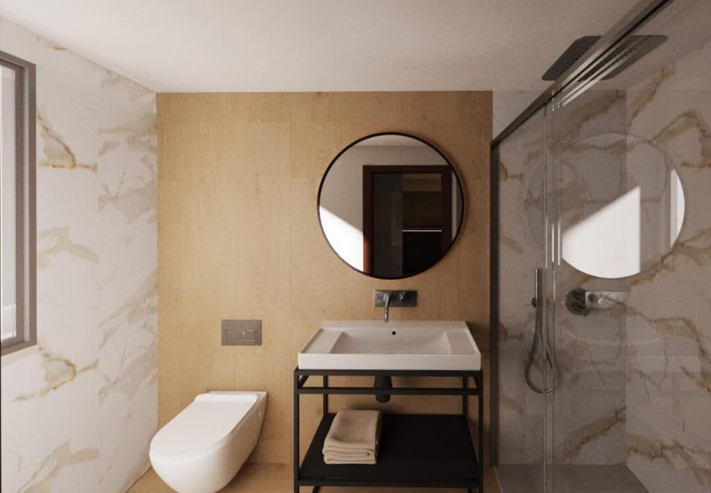 Een moderne badkamer met een wit toilet, een wastafel met een zwarte omlijsting en een spiegel erboven.
