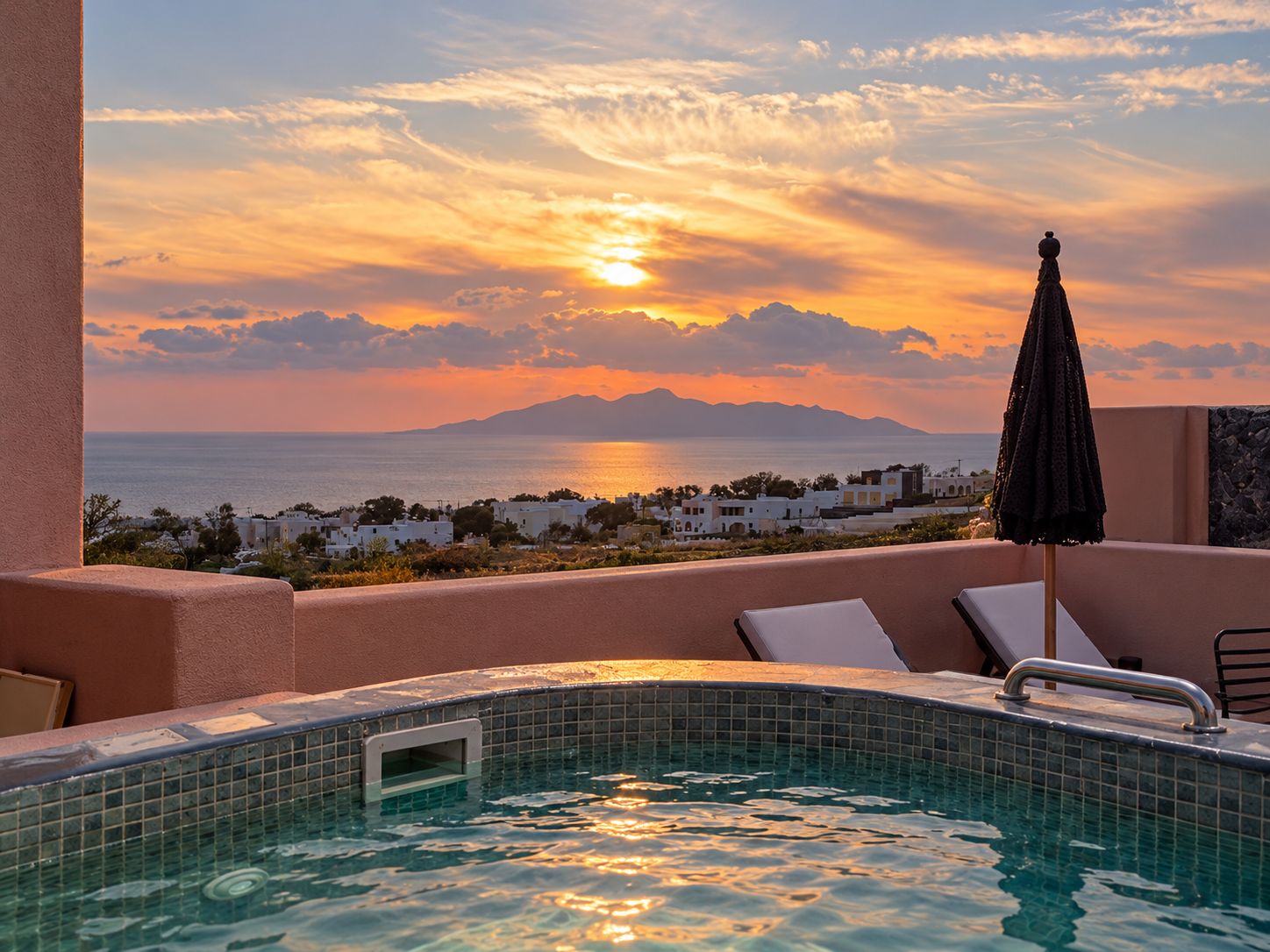 A pool with a view of the sea and a sunset.