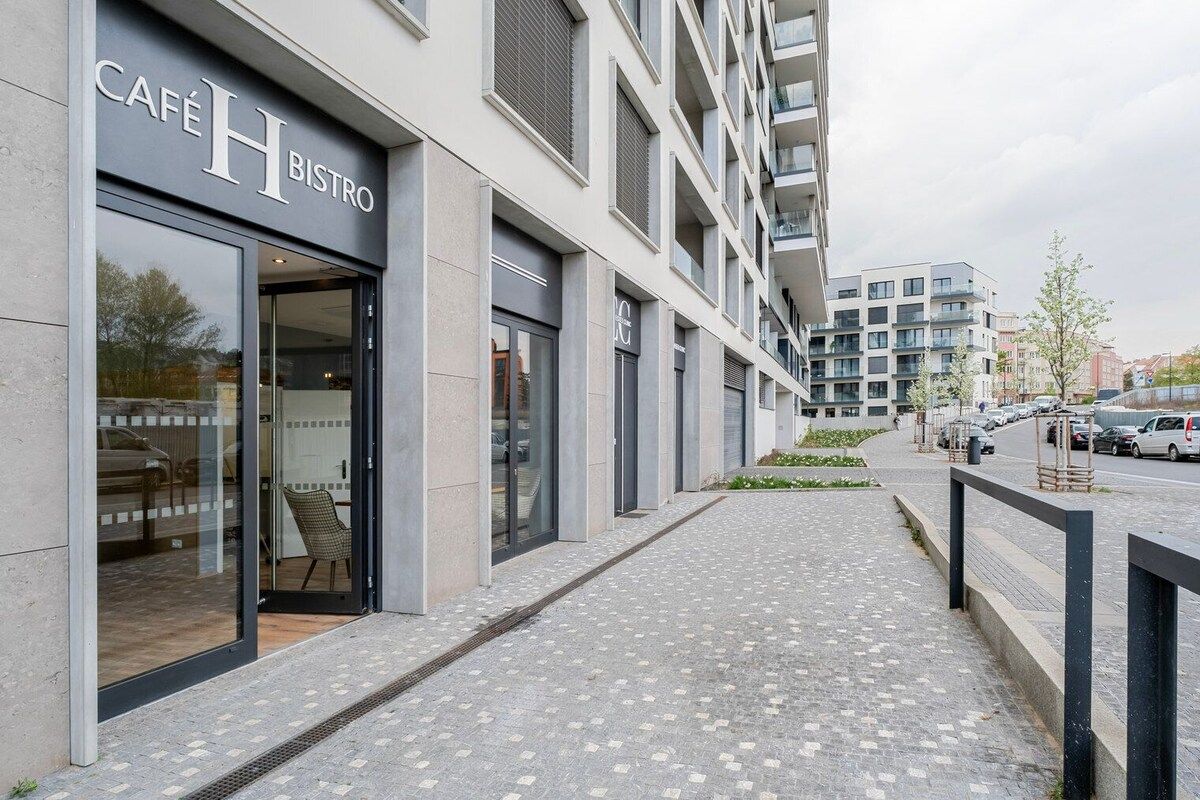 A modern building with a café named 'Café H Bistro' on the ground floor.