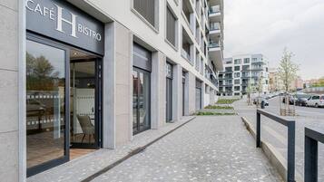 A modern building with a café named 'Café H Bistro' on the ground floor.