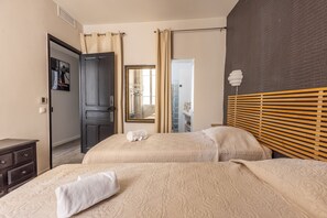 A hotel room with two beds, a dark wooden headboard, a mirror, a wardrobe, and a bathroom visible through an open door. - 2 Chambres -2 Sdb- Balcon- Forville A2b106 (Cannes)
