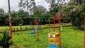 A playground with a slide and swings.
