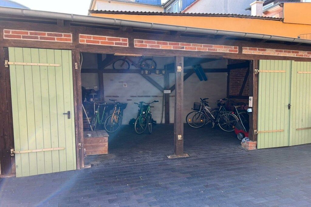 A bicycle storage area with multiple bicycles parked inside.