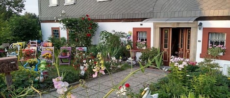 A two-story house with a garden in front.