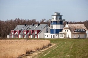 A coastal building with a lighthouse, multiple windows, and a grassy foreground. - Holiday apartment with 2 bedrooms (Breege\/ Juliusruh OT Breege)