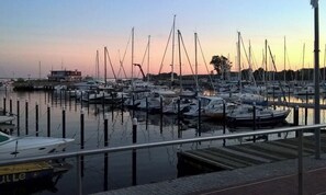 A marina with multiple boats docked at wooden piers. - Holiday home in Damp with swimming pool (Damp)