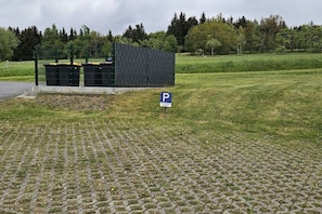 A parking area with a paved surface and a sign indicating parking availability. - Holiday apartment with 2 bedrooms (Altenberg)